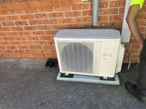 Outdoor split system air conditioner unit during a repair service in Parramatta, Sydney